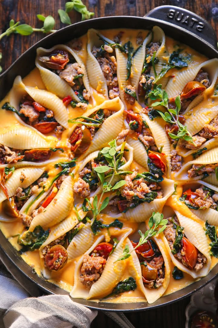 Creamy Butternut Squash Pasta Shells Stuffed with Sausage, Spinach, and Tomatoes, and topped with Pepper Jack Cheese finished