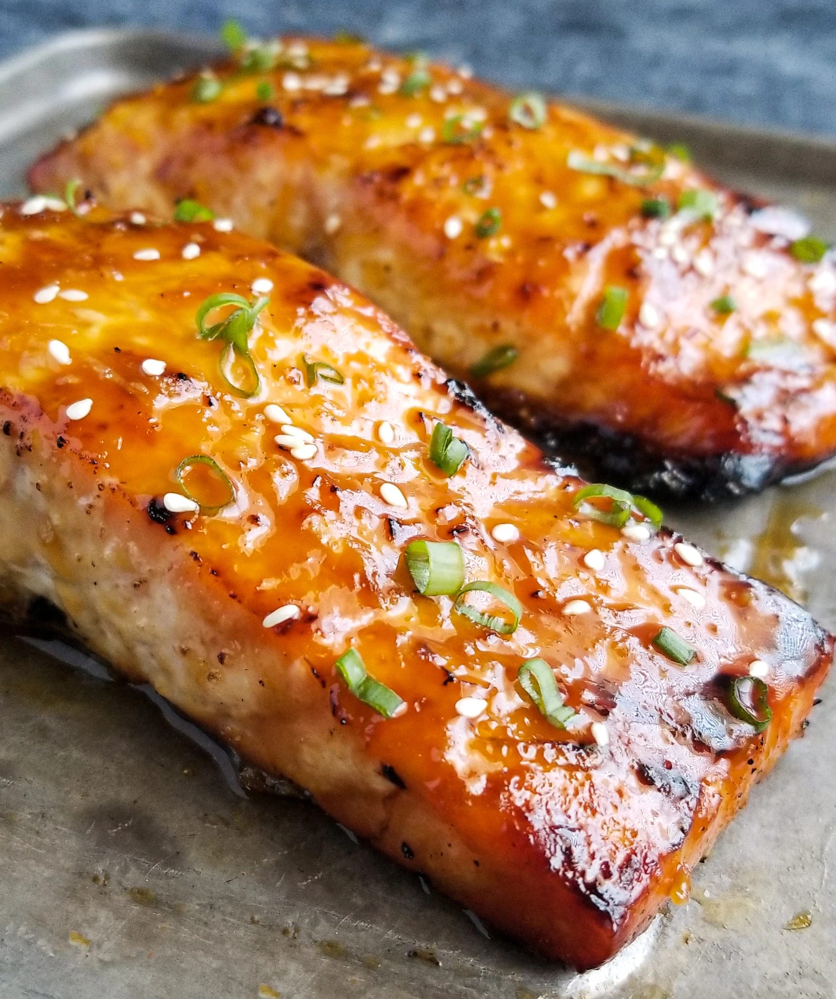 Orange Teriyaki Salmon or Delicious easy baked salmon in a mouthwatering orange teriyaki glaze finished with fresh chopped green onion and sesame seeds. finished