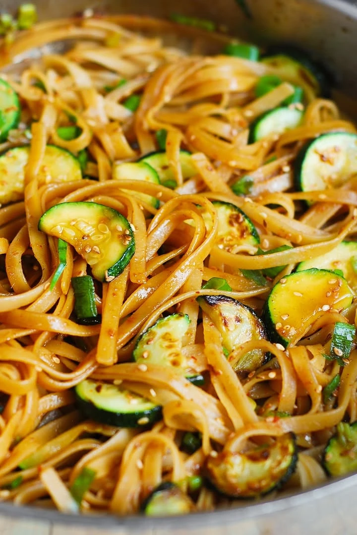 Thai Zucchini Noodles - fettuccine pasta with fresh zucchini and a homemade, spicy Thai sauce, topped with toasted sesame seeds. finished